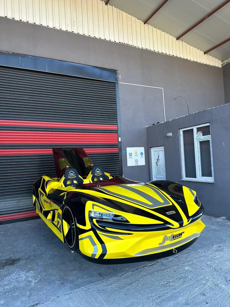 Slide: The Image of 2025 Fabbro Jet Car RR in vibrant yellow and black parked outside a garage. - 38