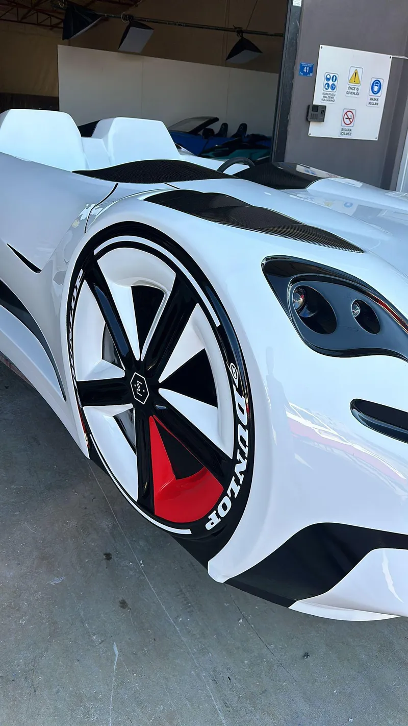 Slide: The Image of 2025 Fabbro Jet Car RR, sleek white design, prominent wheels, futuristic sports car. - 41