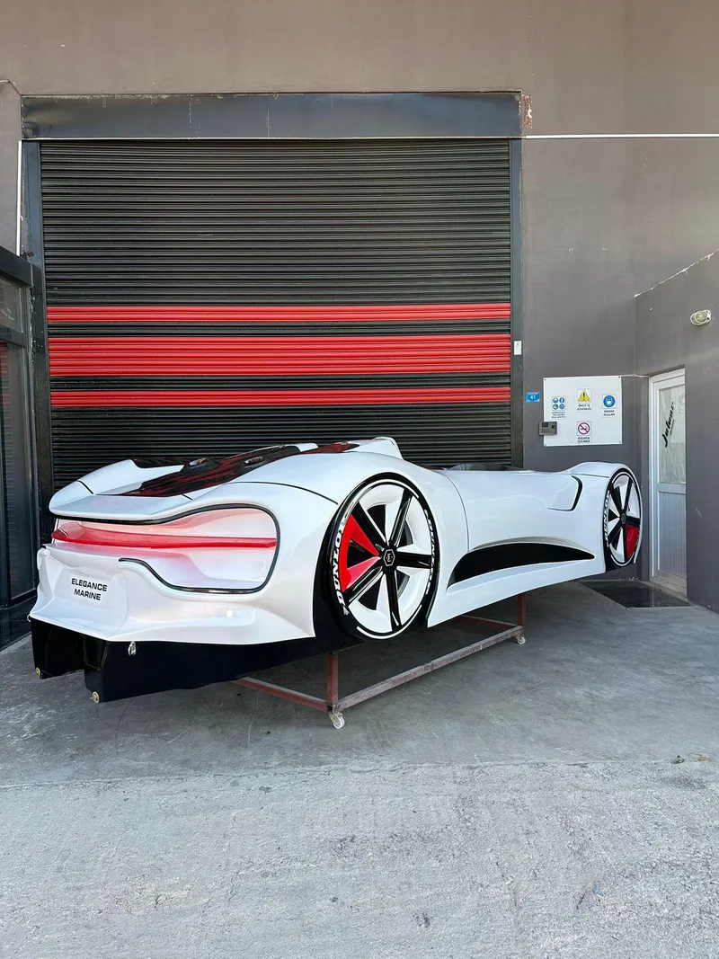 Slide: The Image of Futuristic 2025 Fabbro Jet Car RR displayed in a garage setting. - 42