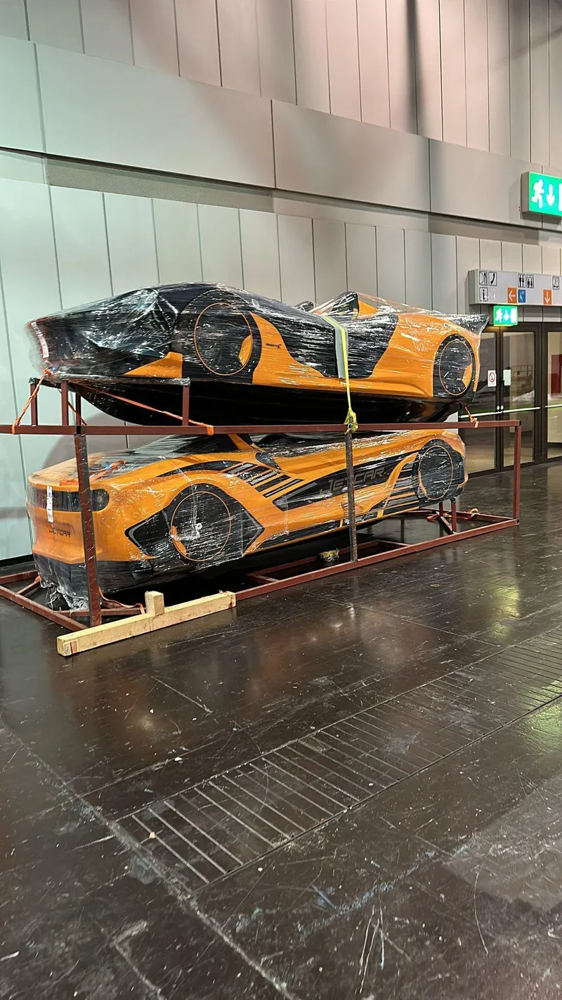 Slide: The Image of 2025 Fabbro Jet Car RR, orange, stacked and wrapped, displayed indoors. - 43