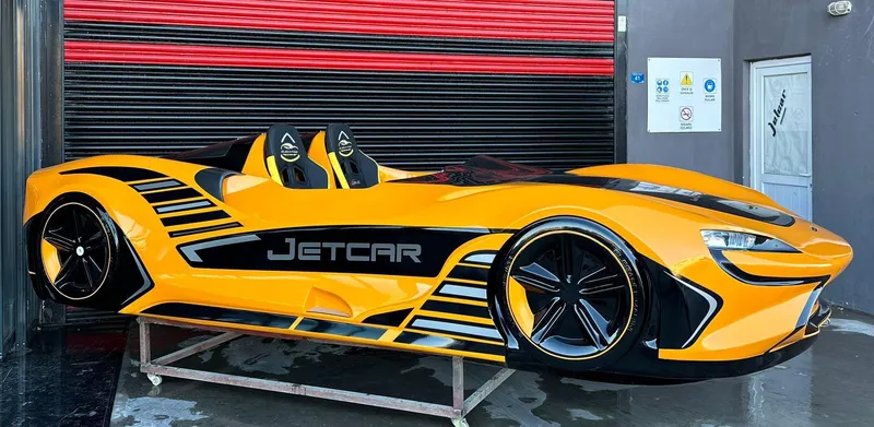 Slide: The Image of Yellow Fabbro Jet Car RR 2025 with sleek design and black accents in a garage setting. - 46