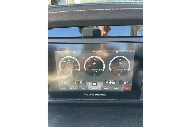 Slide: The Image of Storage compartment of 2022 Crownline 255 SS SURF boat with gray bag inside. - 29