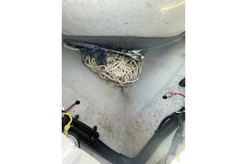 Slide: The Image of 2022 Crownline 255 SS SURF boat interior with coiled rope and wiring. - 31