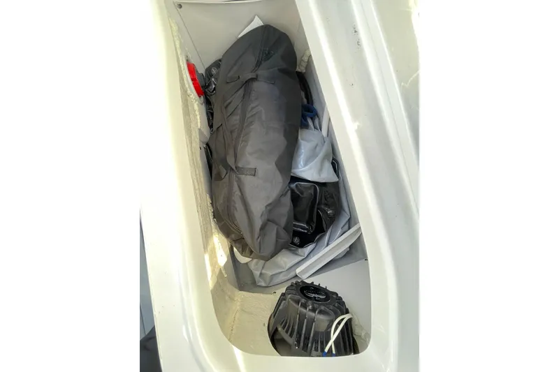 Slide: The Image of Storage compartment of 2022 Crownline 255 SS SURF boat with equipment and gear. - 36