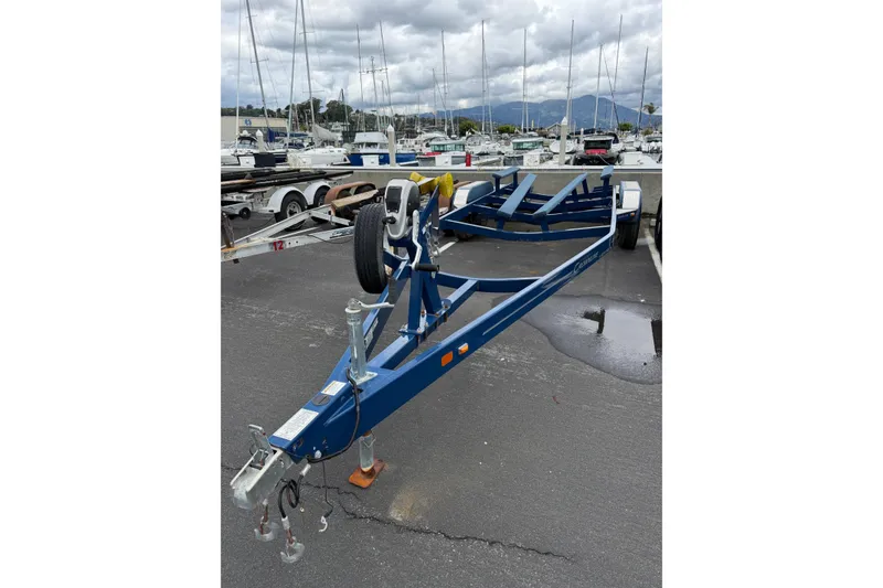 Slide: The Image of Blue boat trailer for 2022 Crownline 255 SS SURF at marina with sailboats. - 40