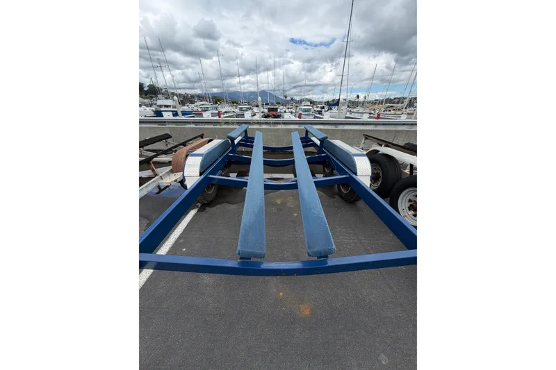 Slide: The Image of Boat trailer for 2022 Crownline 255 SS SURF at marina, cloudy sky background. - 41