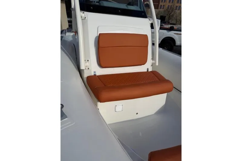 Slide: The Image of 2026 Brig Eagle 6.7 boat with brown cushioned seating, white interior. - 6