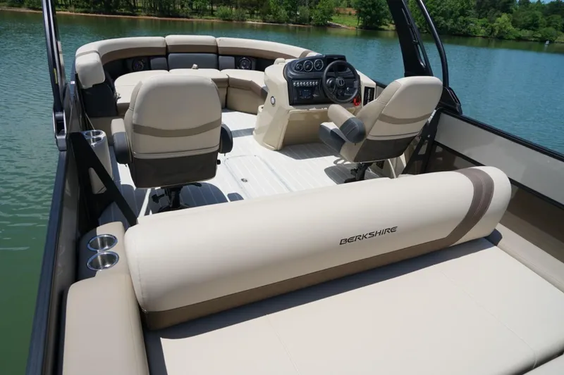 Slide: The Image of 2026 Berkshire 22 UL CTS pontoon boat interior with beige seating and modern dashboard. - 11