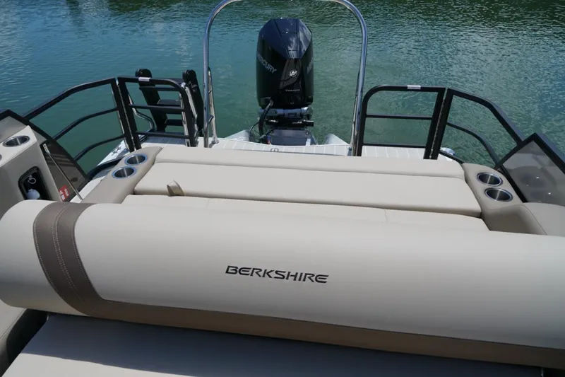 Slide: The Image of 2026 Berkshire 22 UL CTS boat with comfortable seating and Mercury outboard motor on a lake. - 13