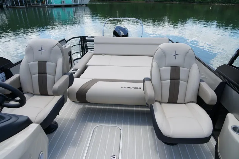 Slide: The Image of 2026 Berkshire 22 UL CTS boat interior with luxurious seating on a serene lake. - 14