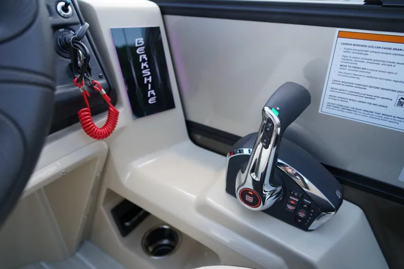 Slide: The Image of Control panel of 2026 Berkshire 22 UL CTS boat with ignition key and throttle lever. - 18