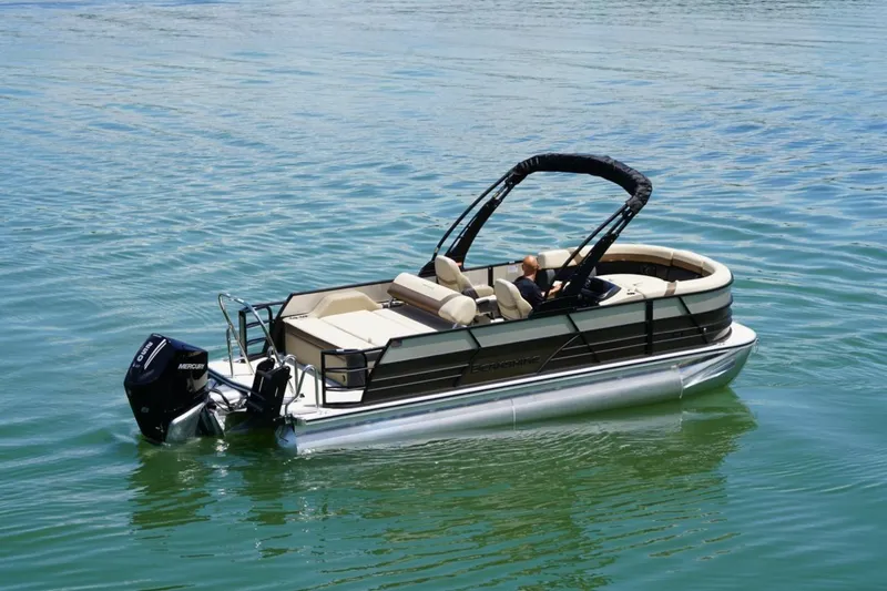 Slide: The Image of 2026 Berkshire 22 UL CTS pontoon boat on calm water, featuring a Mercury outboard motor. - 5