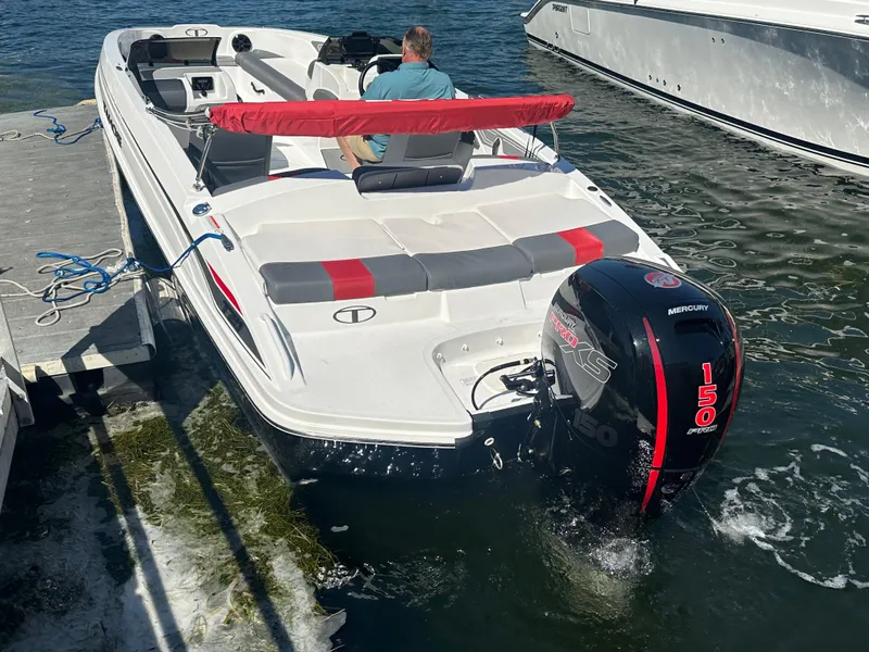 Slide: The Image of 2024 Tahoe T21 boat with Mercury 150 outboard motor docked in water. - 10