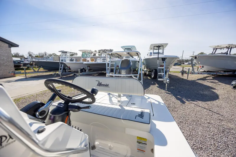 Slide: The Image of 2024 Maverick 17 HPX-S boat displayed in a dealership lot under clear skies. - 12