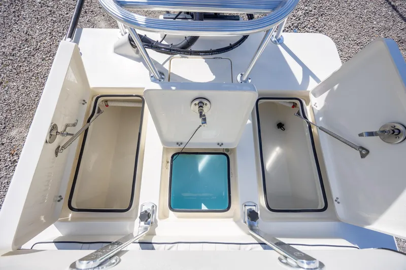 Slide: The Image of 2024 Maverick 17 HPX-S boat storage compartments with open hatches, showcasing interior design. - 14
