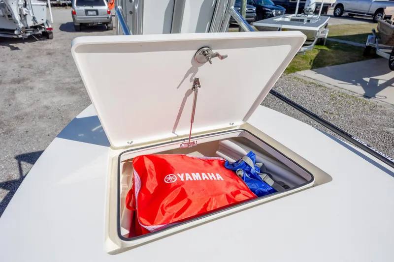 Slide: The Image of 2024 Maverick 17 HPX-S boat storage compartment with Yamaha gear inside. - 17