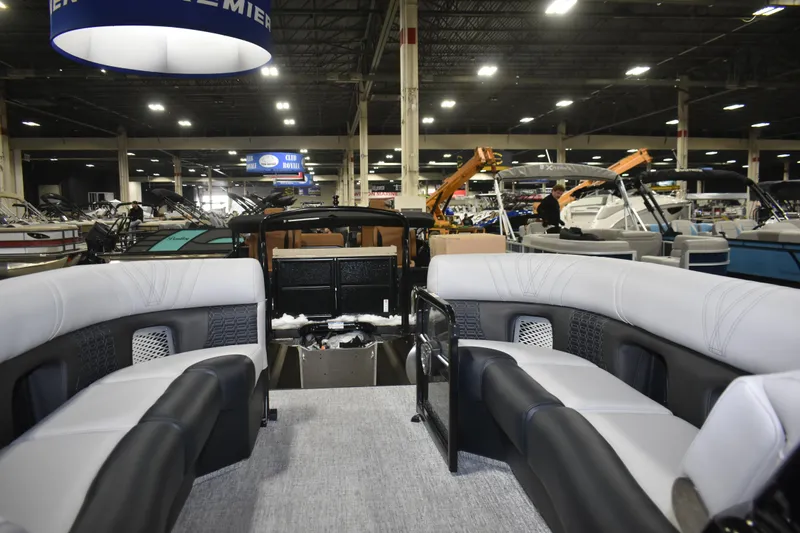 Slide: The Image of 2026 Premier 250 Intrigue RLO-CL pontoon boat interior at a boat show. - 10