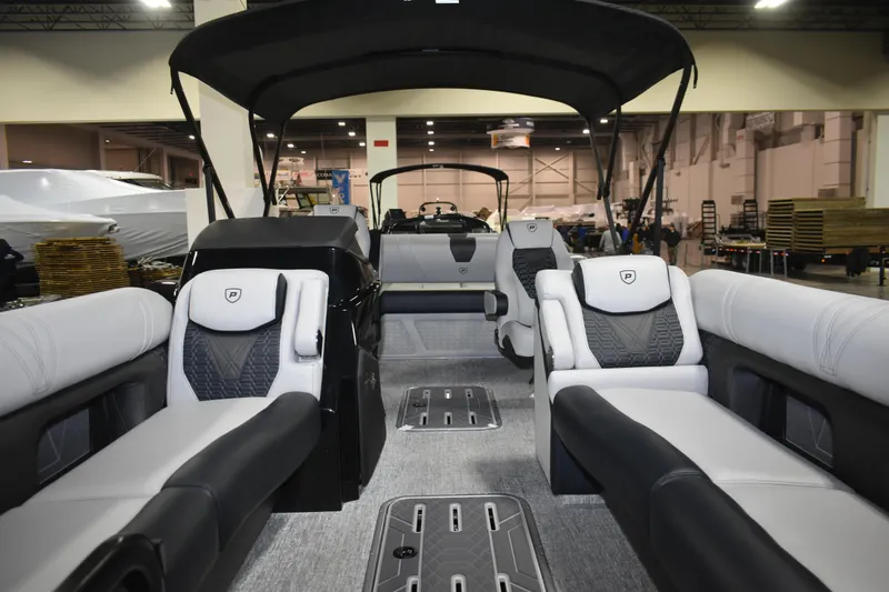 Slide: The Image of 2026 Premier 250 Intrigue RLO - CL pontoon boat interior with luxurious seating and canopy. - 11