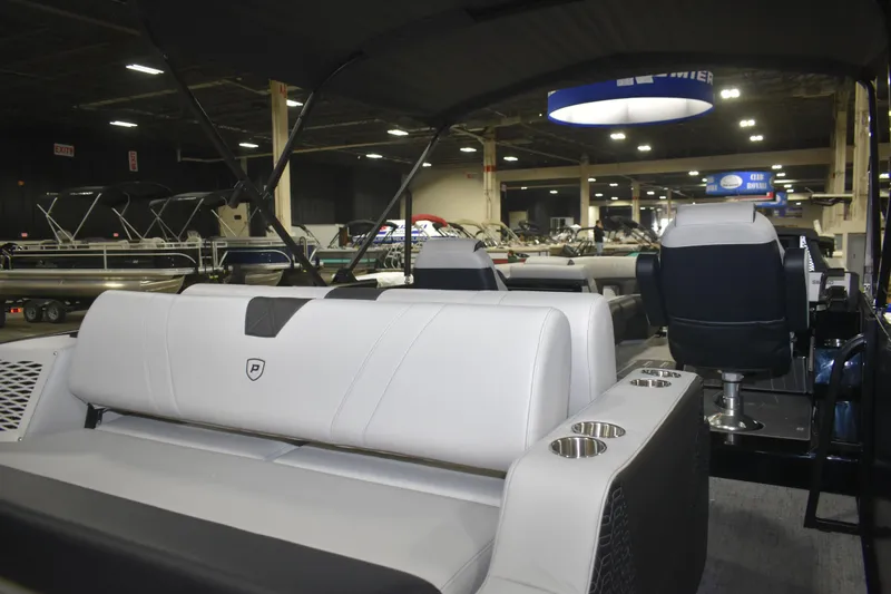 Slide: The Image of 2026 Premier 250 Intrigue RLO - CL pontoon boat interior at a showroom. - 18