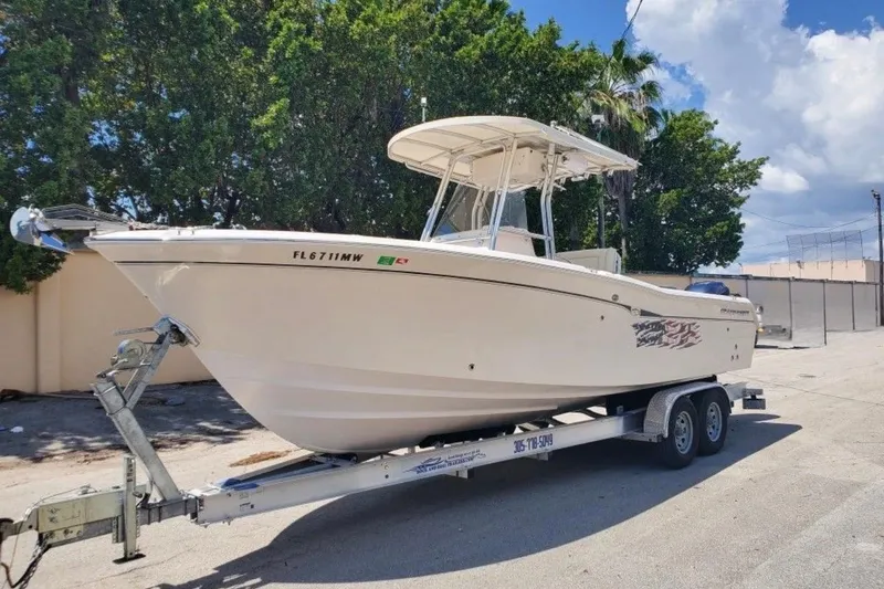 Slide: The Image of 2004 Grady-White Chase 273 boat on trailer, parked outdoors under a clear sky. - 0