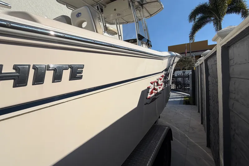 Slide: The Image of 2004 Grady White 273 boat parked beside a wall under clear blue sky. - 10