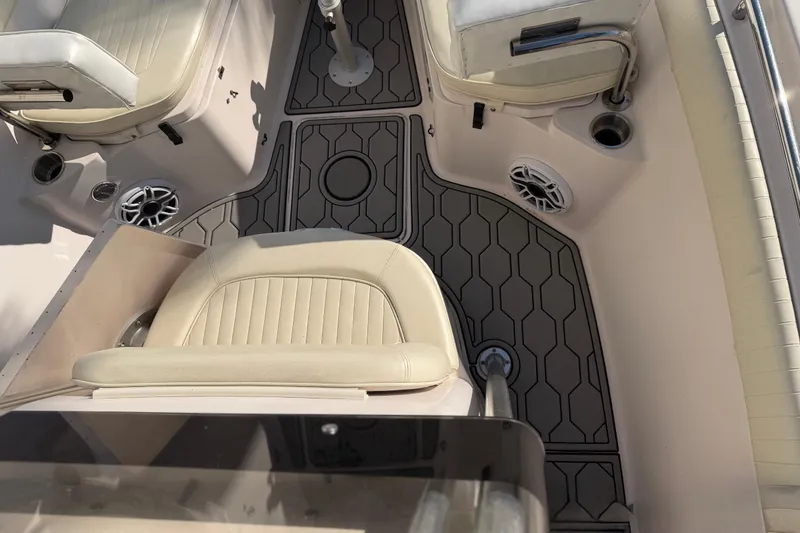 Slide: The Image of 2004 Grady White 273 boat interior with cushioned seats and hexagonal floor design. - 102