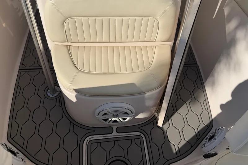 Slide: The Image of 2004 Grady White 273 boat interior with cushioned seat and hexagonal floor design. - 107