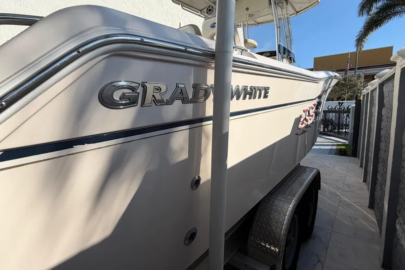 Slide: The Image of 2004 Grady White 273 boat on trailer, side view with logo visible. - 11
