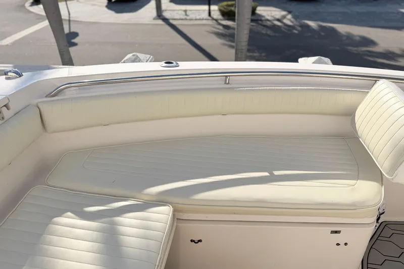 Slide: The Image of 2004 Grady White 273 boat interior with white cushioned seating. - 118