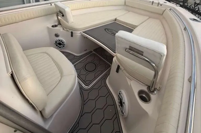 Slide: The Image of 2004 Grady-White Chase 273 boat interior with cushioned seating and modern flooring. - 120