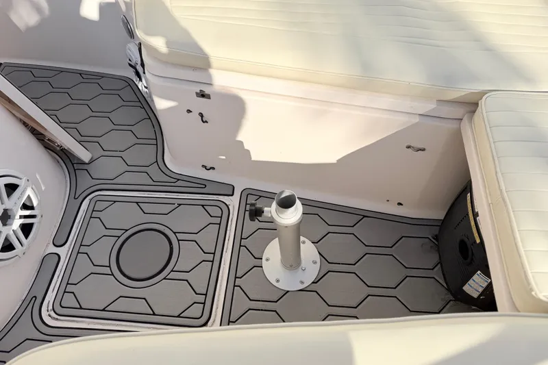 Slide: The Image of 2004 Grady White 273 boat interior with hexagonal patterned flooring and cushioned seating. - 122