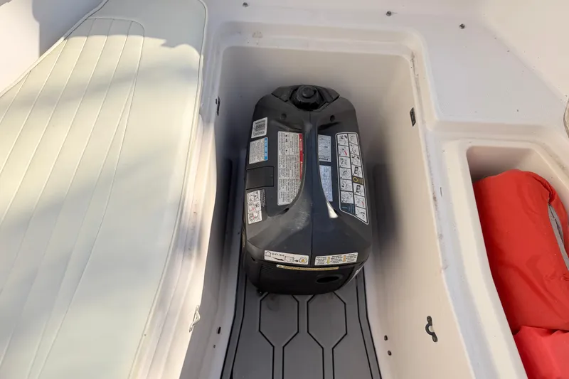 Slide: The Image of Storage compartment in a 2004 Grady White 273 boat with a fuel container. - 123