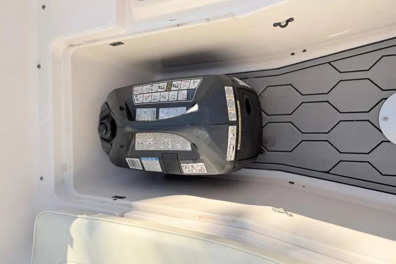 Slide: The Image of Storage compartment in a 2004 Grady White 273 boat with equipment inside. - 124