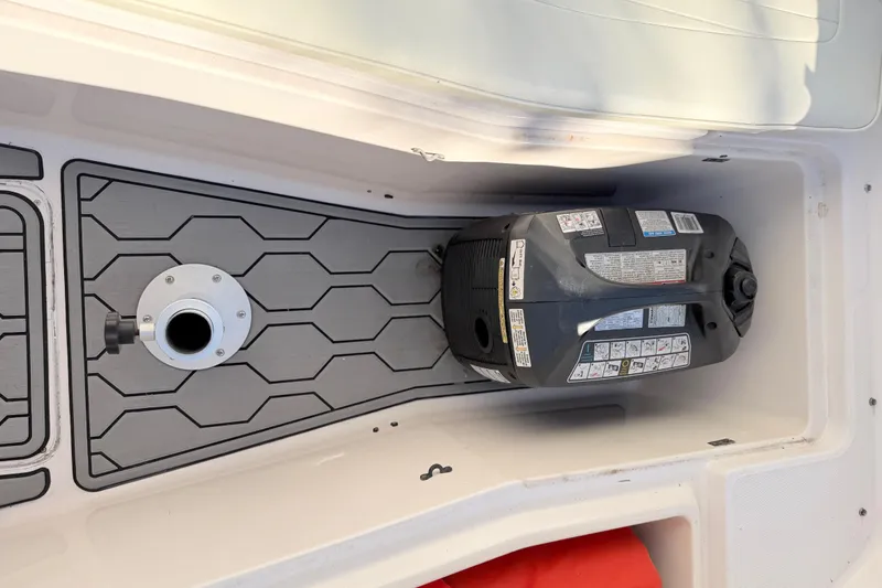 Slide: The Image of 2004 Grady White 273 boat compartment with engine and textured flooring. - 125