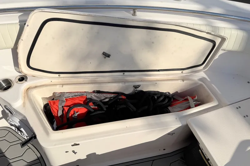 Slide: The Image of Open storage compartment on 2004 Grady White 273 boat with life jacket and ropes. - 131