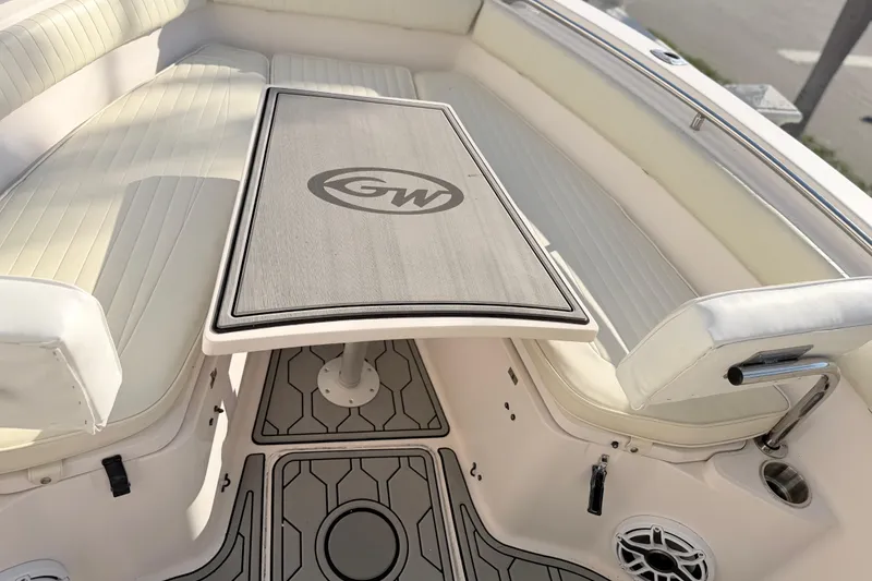 Slide: The Image of 2004 Grady White 273 boat interior with cushioned seating and table. - 134