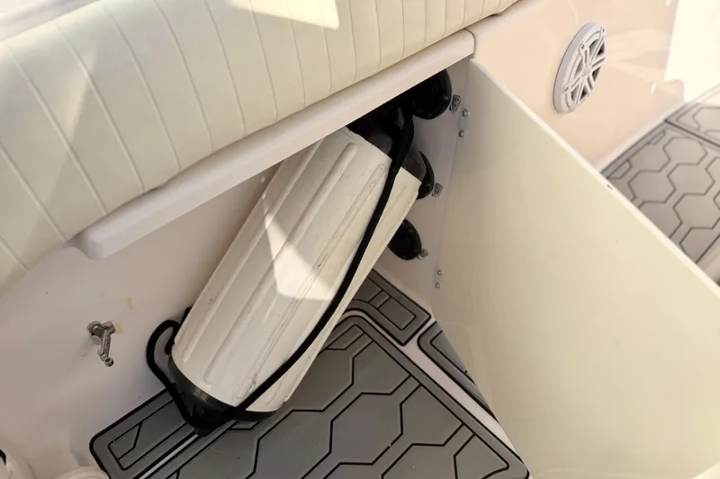 Slide: The Image of 2004 Grady White 273 boat interior with fender storage and cushioned seating. - 139