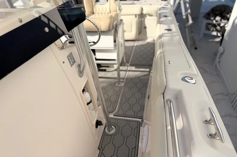 Slide: The Image of 2004 Grady White 273 boat interior with seating and safety equipment. - 140
