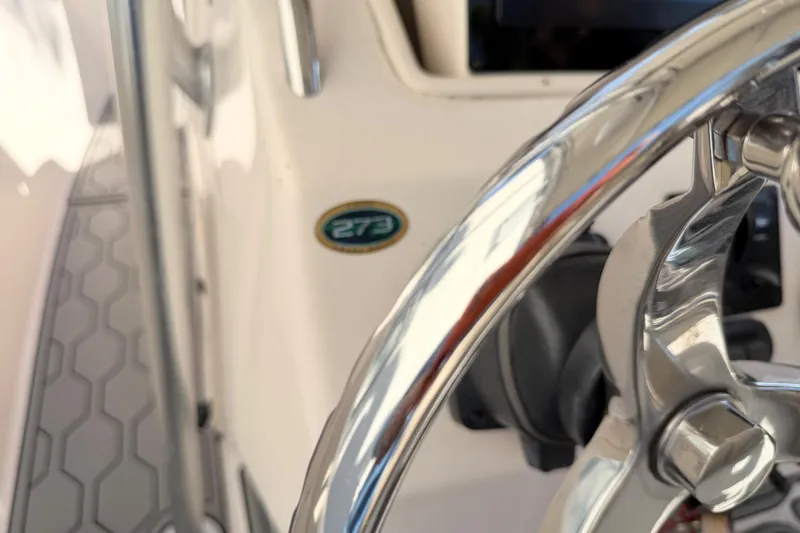 Slide: The Image of Close-up of a 2004 Grady White 273 boat steering wheel and model badge. - 144