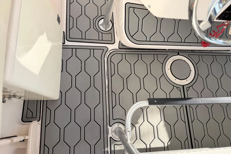 Slide: The Image of 2004 Grady White 273 boat deck with hexagonal pattern flooring and metal railings. - 148