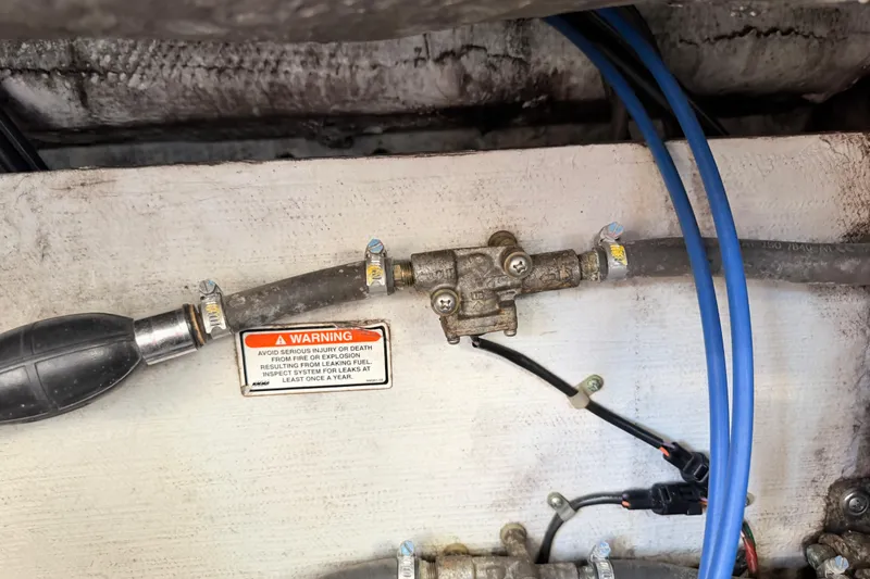 Slide: The Image of Fuel system components with warning label on 2004 Grady White 273 boat. - 151