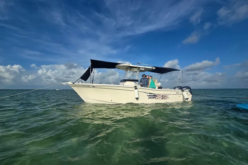 Slide: The Image of 2004 Grady-White Chase 273 boat anchored on clear ocean water under a blue sky. - 154