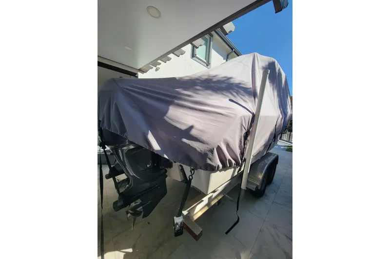 Slide: The Image of Covered 2004 Grady-White Chase 273 boat on trailer, parked under a canopy. - 158