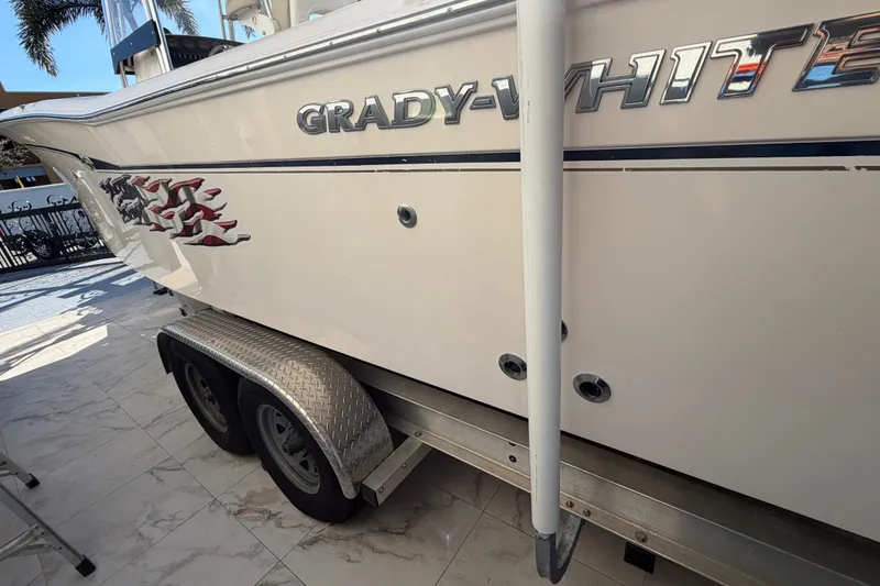 Slide: The Image of 2004 Grady-White 273 boat on trailer, side view with logo and graphics. - 19