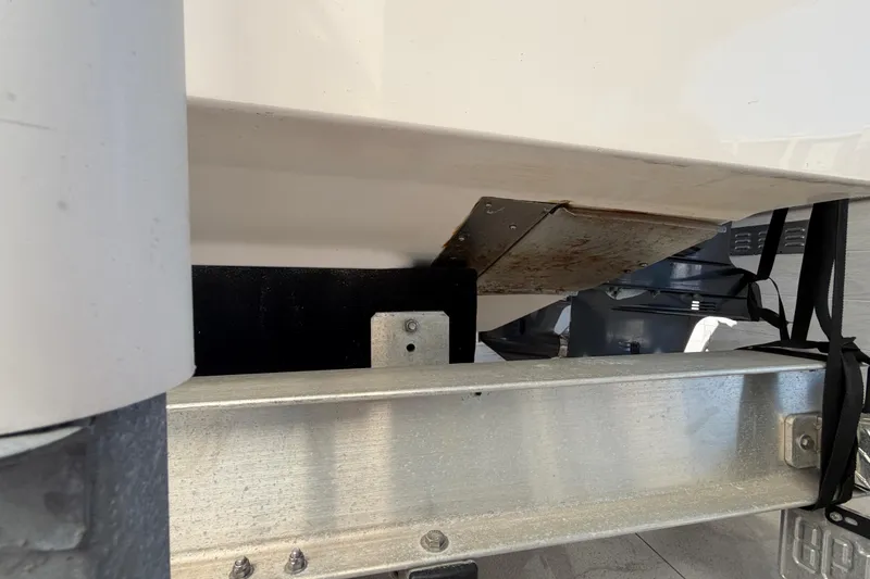 Slide: The Image of 2004 Grady White 273 boat underside with metal support and visible rust. - 25