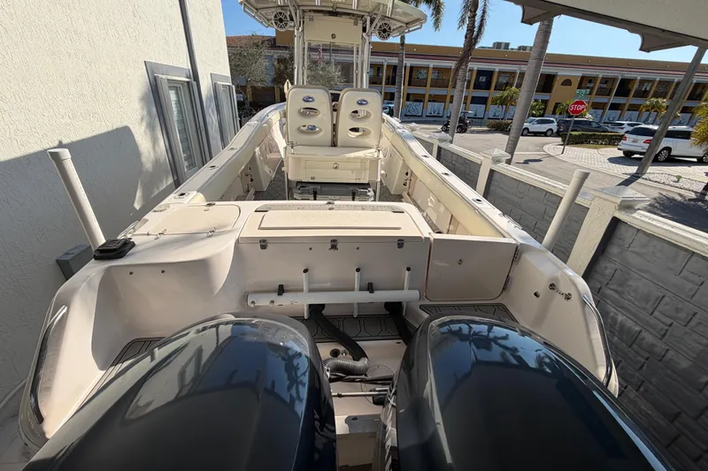 Slide: The Image of 2004 Grady White 273 boat with dual engines, docked near a building. - 27