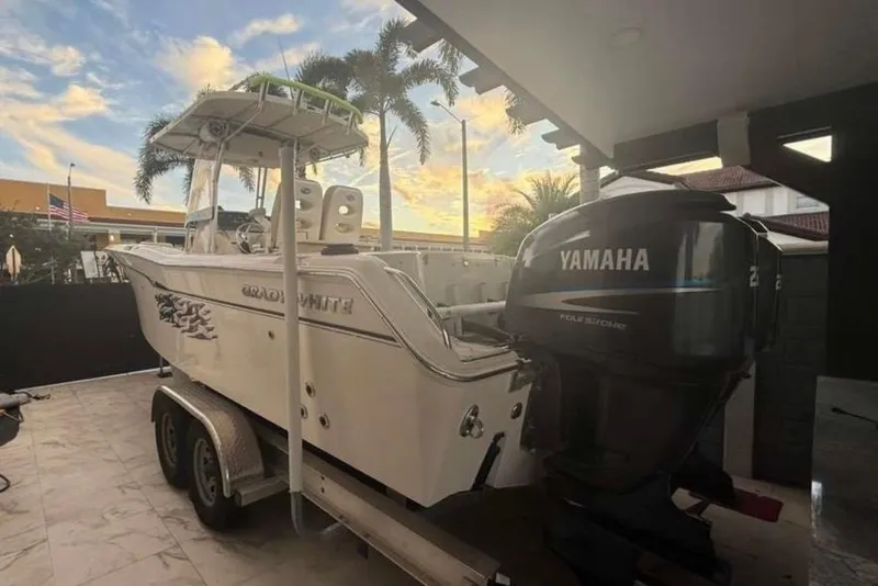 Slide: The Image of 2004 Grady-White Chase 273 boat with Yamaha engine on trailer, palm trees in background. - 3