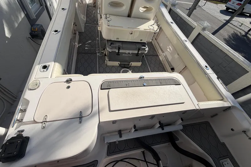 Slide: The Image of 2004 Grady White 273 boat interior with storage compartments and equipment. - 32
