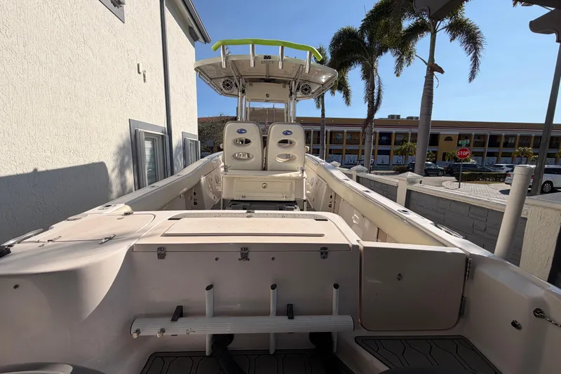 Slide: The Image of 2004 Grady White 273 boat with seating, docked near palm trees and buildings. - 34