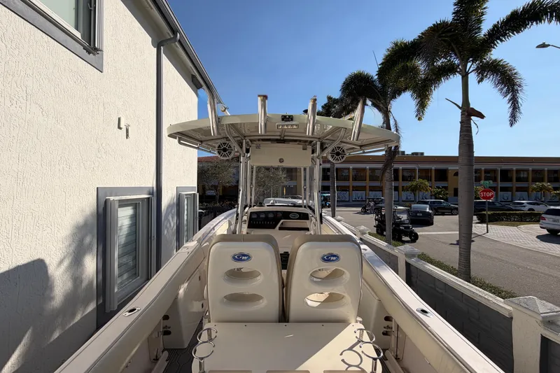 Slide: The Image of 2004 Grady White 273 boat docked near palm trees and building. - 35